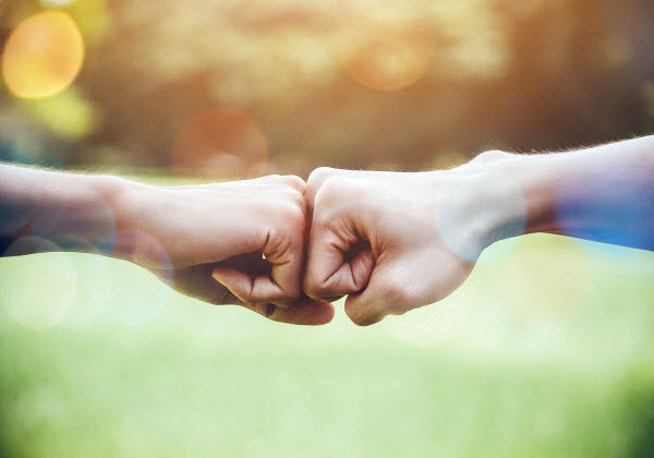 Hands of two man people fist bump team teamwork and partnership business success.